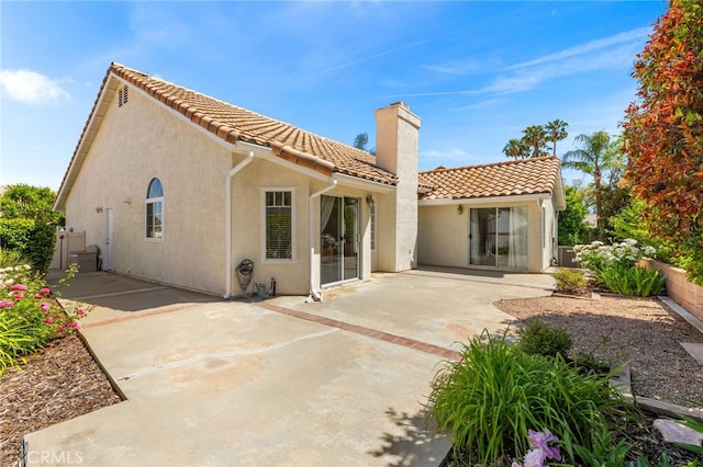 429 Indian Wells Rd, Banning, CA 92220 - rear view of property featuring a chimney, a tile roof, stucco siding, and a patio area
