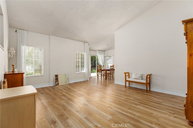 429 Indian Wells Rd, Banning, CA 92220 - living room featuring a textured ceiling, light wood-type flooring, and baseboards