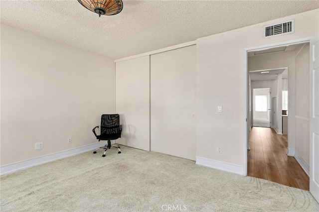 429 Indian Wells Rd, Banning, CA 92220 - unfurnished bedroom featuring a textured ceiling, carpet flooring, a closet, and baseboards