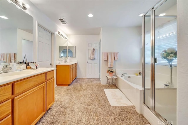 full bath featuring visible vents, a bath, two vanities, a shower stall, and a sink