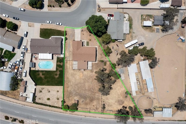 aerial view of property's location with property parcel outlined and a pool area