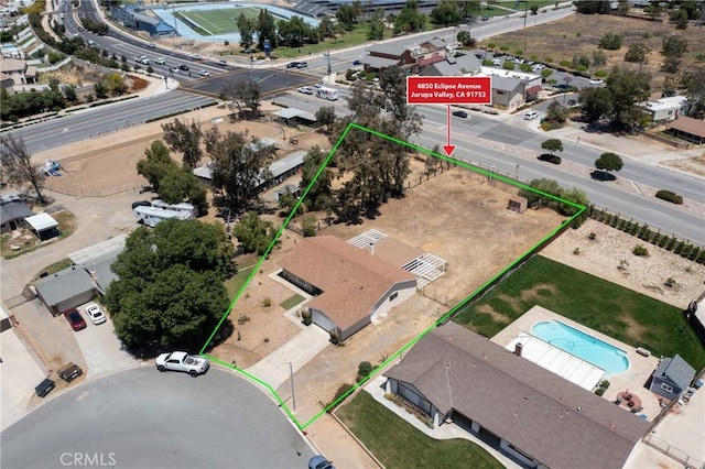 aerial view of property's location featuring property parcel outlined and a pool area