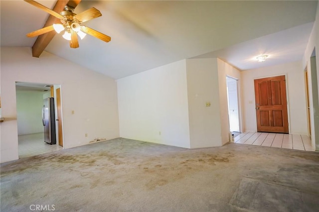 unfurnished living room featuring carpet flooring, ceiling fan, and lofted ceiling with beams