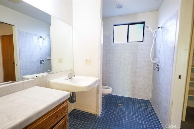full bath with a sink, tile patterned flooring, toilet, a bidet, and tiled shower