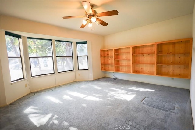empty room featuring baseboards, ceiling fan, and carpet