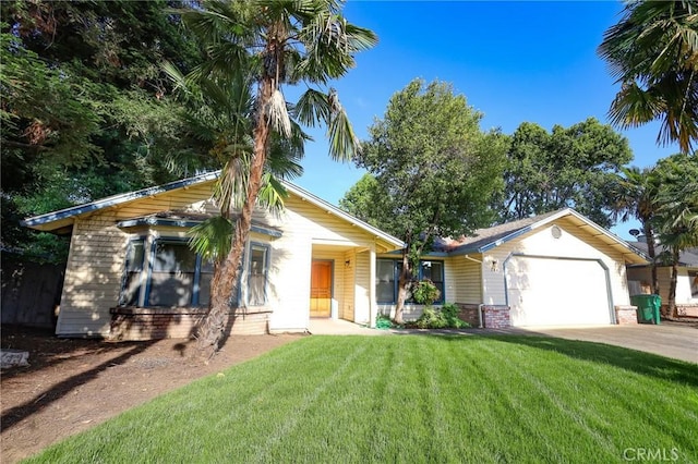 ranch-style home featuring an attached garage, concrete driveway, a front lawn, and brick siding