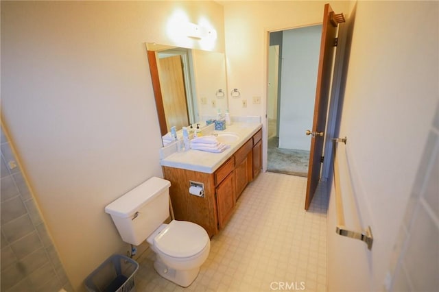 bathroom with vanity, tile patterned floors, and toilet