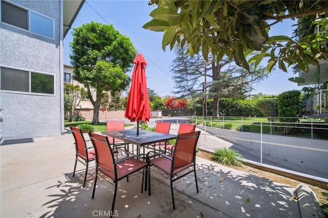 view of patio / terrace featuring fence and outdoor dining area