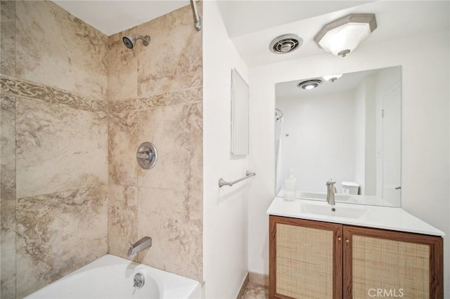 bathroom featuring baseboards, visible vents, washtub / shower combination, and vanity