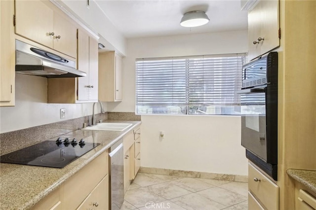 kitchen with a sink, light countertops, baseboards, under cabinet range hood, and black appliances