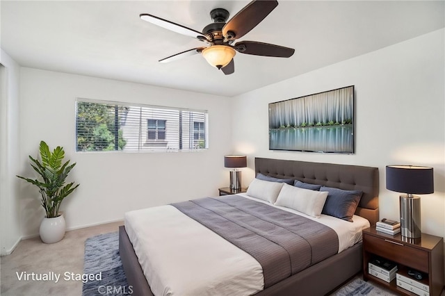 carpeted bedroom with baseboards and ceiling fan