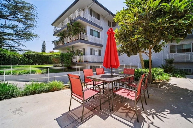 view of patio with fence and outdoor dining space
