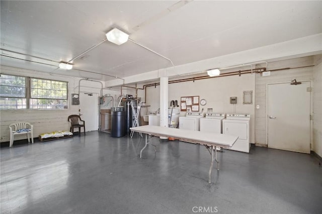 garage with washing machine and clothes dryer and a garage door opener