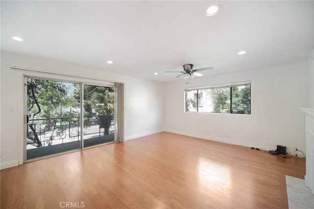 unfurnished room featuring light wood-style floors, a ceiling fan, recessed lighting, and a wealth of natural light