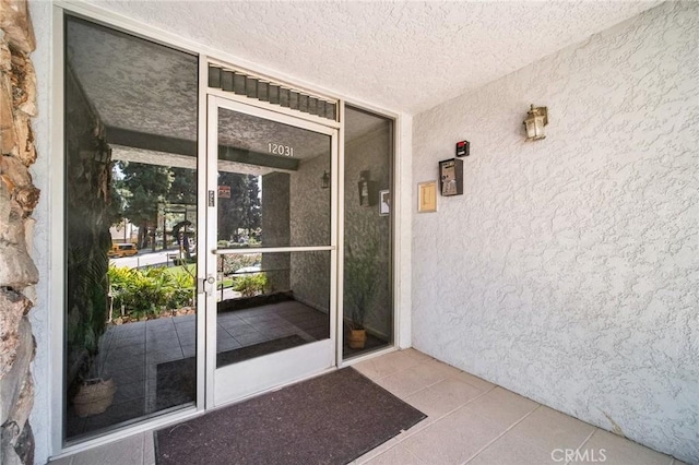12031 Beverly Blvd Unit 1D, Whittier, CA 90601 - view of exterior entry with stucco siding and covered porch
