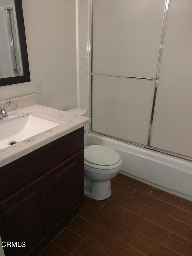 2655 Anchor Ave, Port Hueneme, CA 93041 - full bath with vanity, shower / bath combination with glass door, toilet, and wood tiled floor