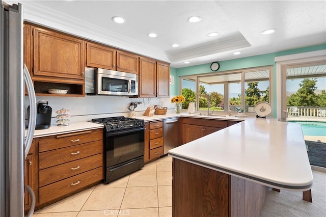 5410 Via, San Jacinto, Riverside, CA 92506 - kitchen featuring stainless steel appliances, a peninsula, healthy amount of natural light, brown cabinetry, and recessed lighting