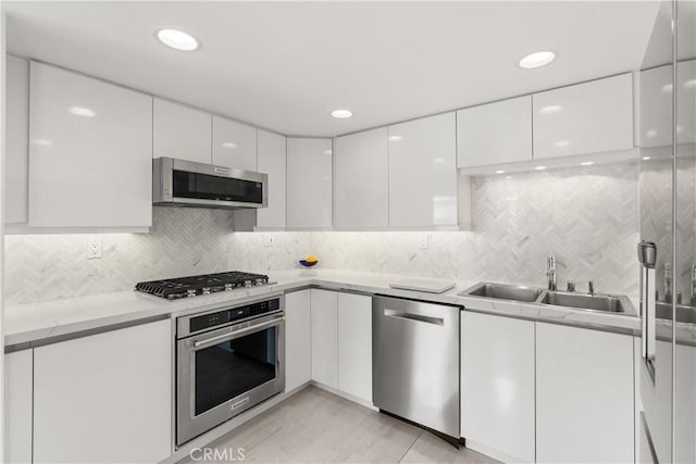 kitchen with white cabinetry, appliances with stainless steel finishes, and modern cabinets