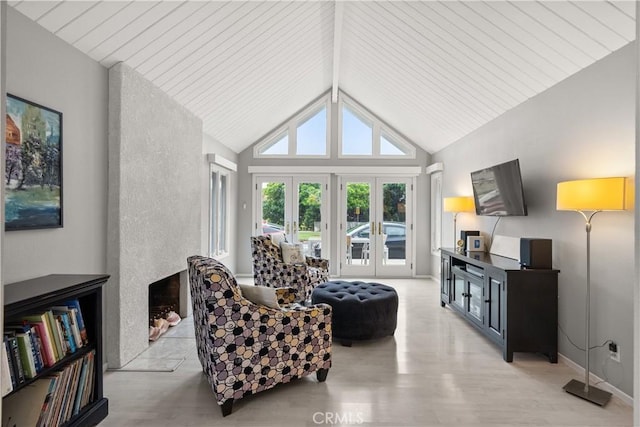living area with french doors, wood finished floors, and vaulted ceiling