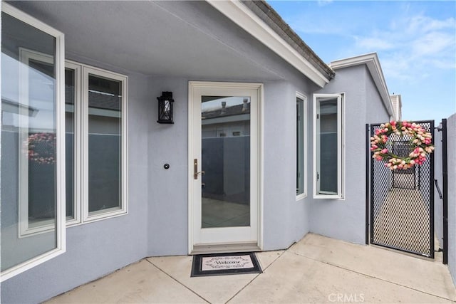 property entrance with stucco siding