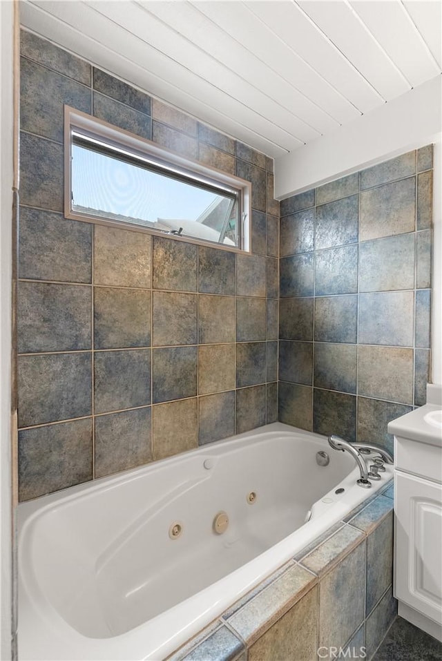 bathroom with vanity and a whirlpool tub