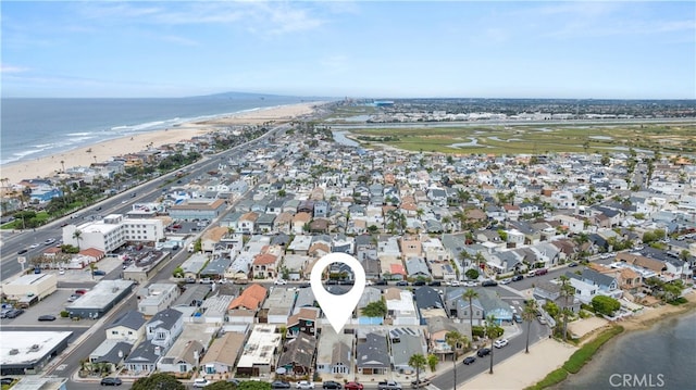 drone / aerial view with a view of the beach, a residential view, and a water view