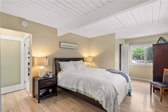 bedroom with light wood-type flooring, baseboards, wood ceiling, and beamed ceiling