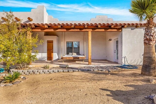 7423 Juniper Rd, Joshua Tree, CA 92252 - back of house with a patio and stucco siding