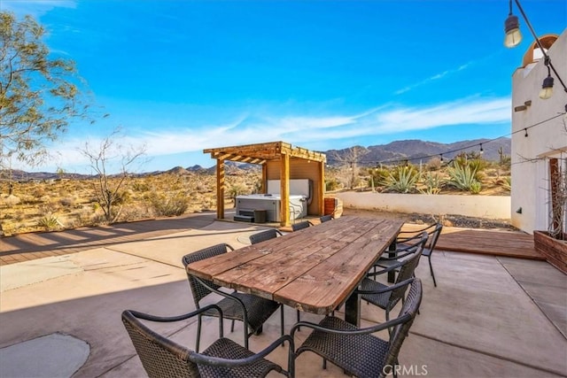 7423 Juniper Rd, Joshua Tree, CA 92252 - view of patio / terrace with a hot tub, a pergola, outdoor dining area, and a mountain view