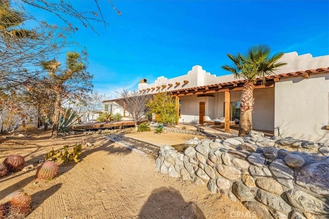 7423 Juniper Rd, Joshua Tree, CA 92252 - rear view of property featuring a patio and stucco siding
