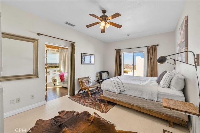 7423 Juniper Rd, Joshua Tree, CA 92252 - bedroom with visible vents, baseboards, ceiling fan, and wood finished floors