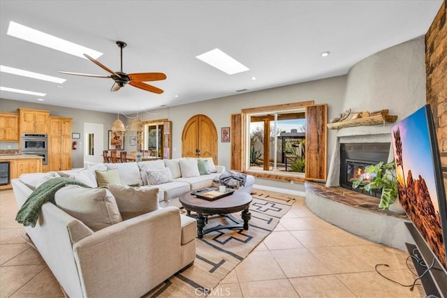 7423 Juniper Rd, Joshua Tree, CA 92252 - living area with a skylight, light tile patterned floors, and a glass covered fireplace