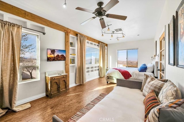 7423 Juniper Rd, Joshua Tree, CA 92252 - bedroom with baseboards, a ceiling fan, wood finished floors, and visible vents
