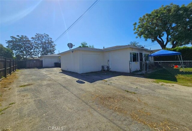 1412 S White Ave, Pomona, CA 91766 - view of side of home featuring stucco siding, a gate, and fence