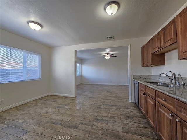 1412 S White Ave, Pomona, CA 91766 - kitchen featuring ceiling fan, light stone counters, a sink, dishwasher, and visible vents