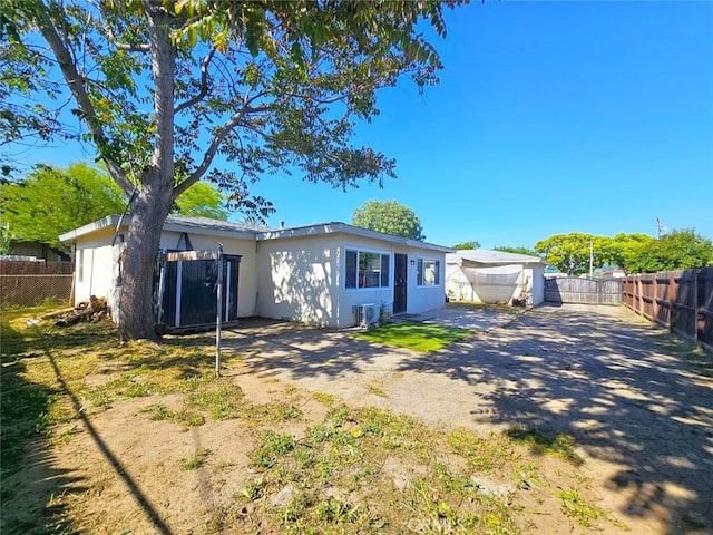 1412 S White Ave, Pomona, CA 91766 - back of property with central AC unit, stucco siding, and fence private yard