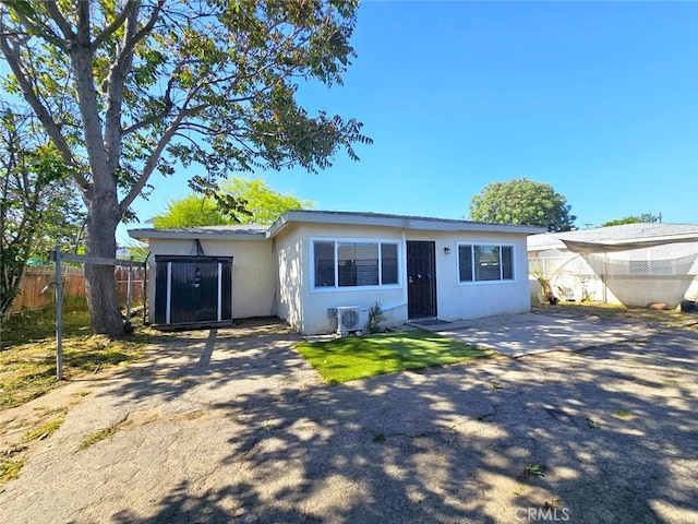 1412 S White Ave, Pomona, CA 91766 - view of front of home featuring stucco siding, ac unit, and fence