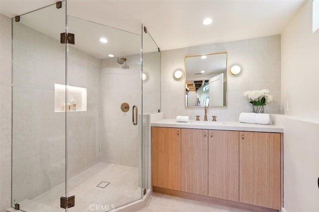 bathroom featuring vanity, a shower stall, and recessed lighting