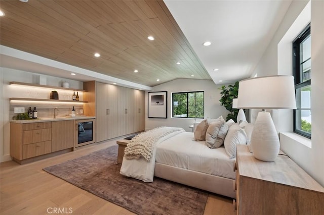bedroom with indoor wet bar, light wood-style floors, recessed lighting, wooden ceiling, and vaulted ceiling