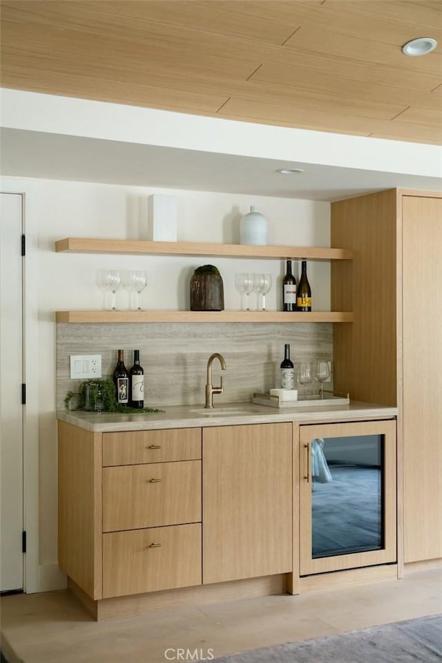 bar featuring indoor wet bar and a sink
