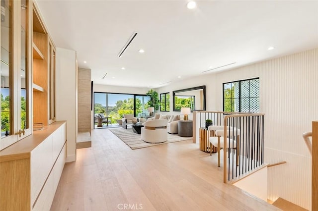 living area with light wood-type flooring and recessed lighting