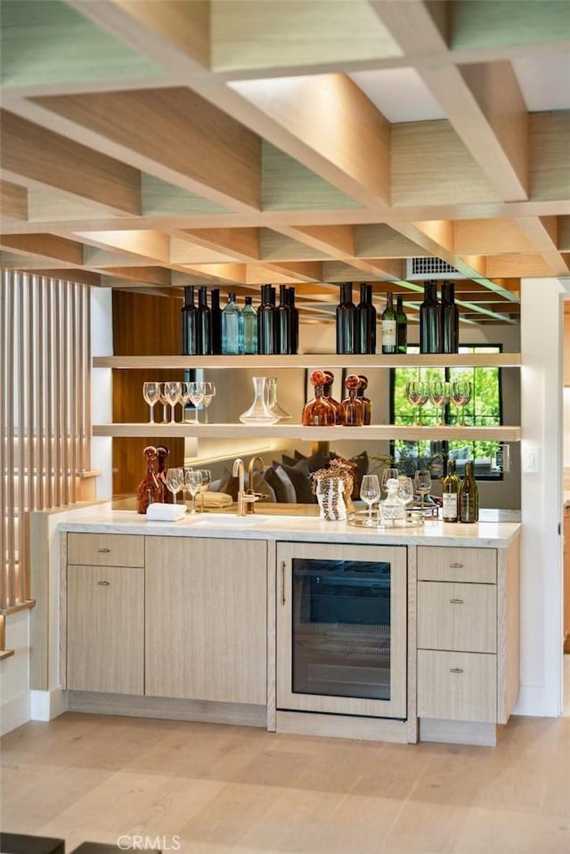 bar featuring indoor wet bar and beverage cooler