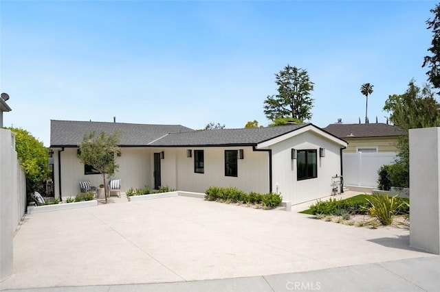 ranch-style house with a patio area and fence