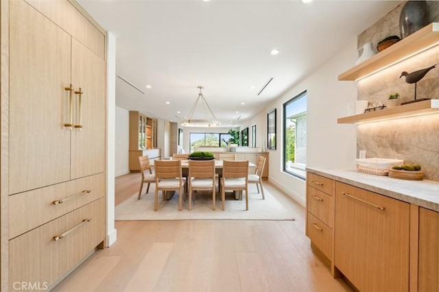 dining space with recessed lighting, baseboards, and light wood-style floors