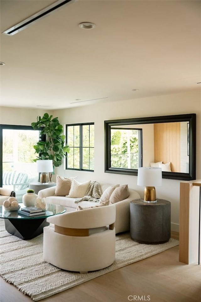 living area with a healthy amount of sunlight and wood finished floors