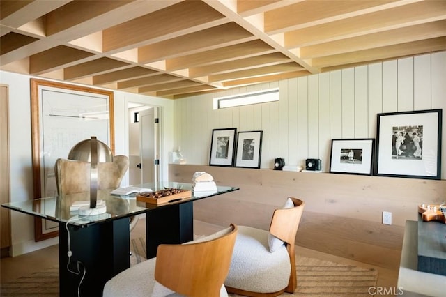 dining space featuring beamed ceiling