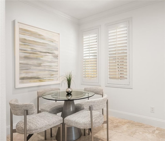 dining room featuring baseboards and ornamental molding
