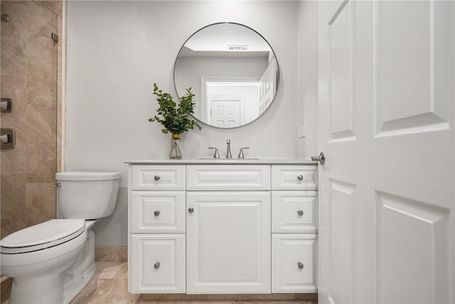 full bathroom featuring vanity, toilet, baseboards, visible vents, and a stall shower