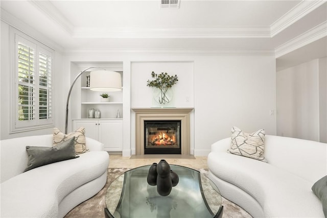 living area featuring visible vents, ornamental molding, a fireplace with flush hearth, and built in shelves