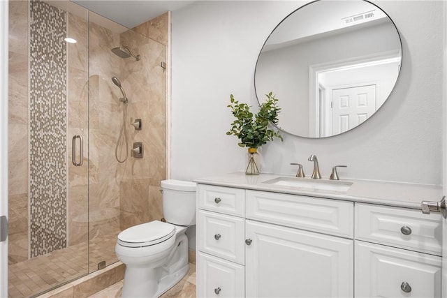 bathroom with visible vents, a stall shower, toilet, and vanity